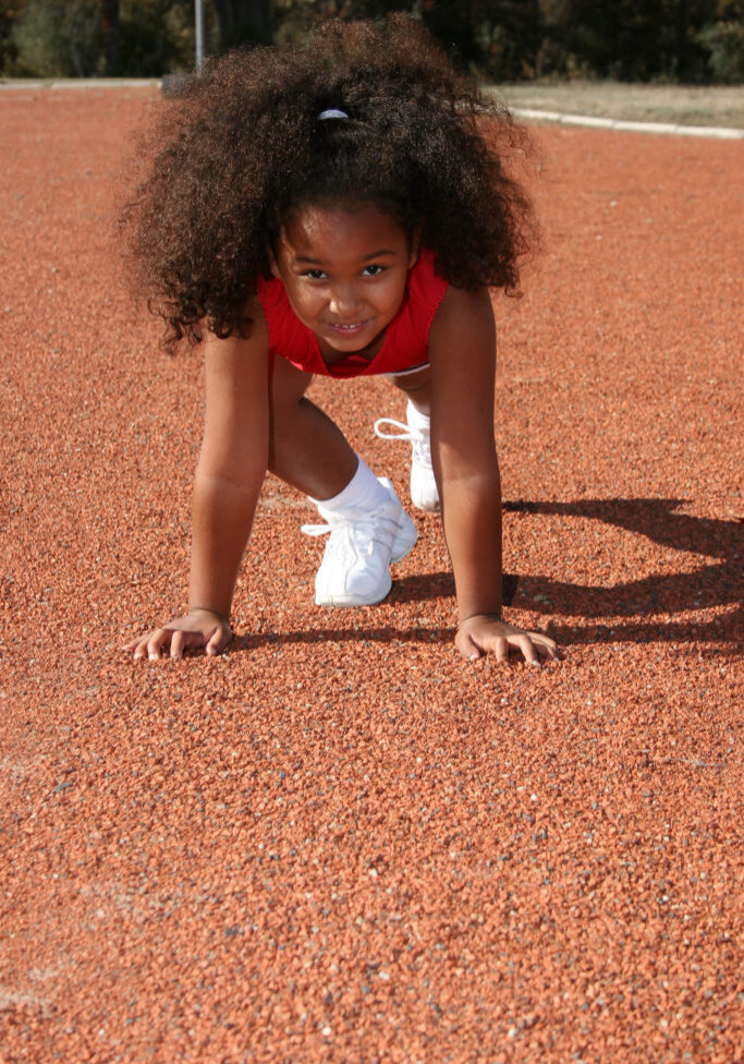 Adorable five year old African American Girl on school track.